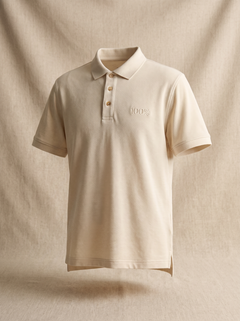 The Bmbū 100% Phat Collar Polo in Raw Oatmeal, front view with the tone-on-tone embroidered 100% mark at the left breast and three laser-engraved bamboo buttons